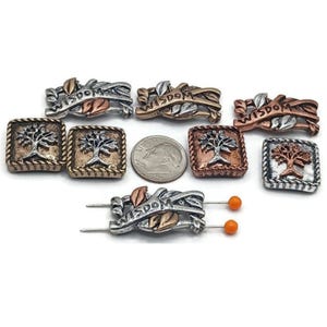 May include: Assortment of silver, copper, and gold tone metal charms with a tree and the word "Wisdom" on them. The charms are in various shapes and sizes.