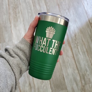 May include: Green stainless steel tumbler with a silver lid and a white graphic of a potted succulent plant. The text "WHAT THE FUCCULENT" is printed in silver on the tumbler.