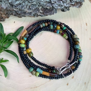 Boho black beaded wrap bracelet,  with colorful aged Picasso beads in red, brown, green and turquoise