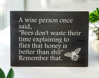 Wise saying on wooden sign plaque