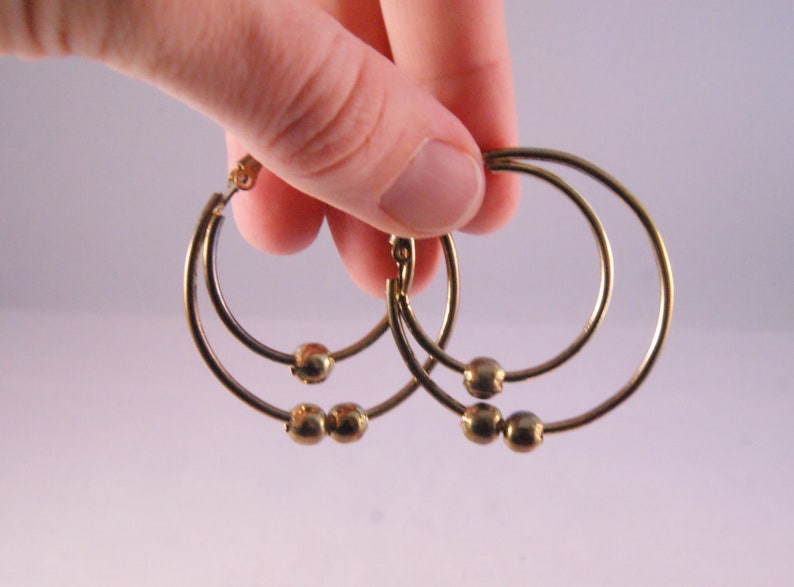 Gold tone pierced double hoop earrings with beads