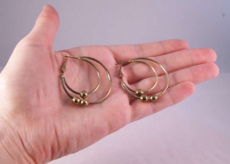 Gold tone pierced double hoop earrings with beads