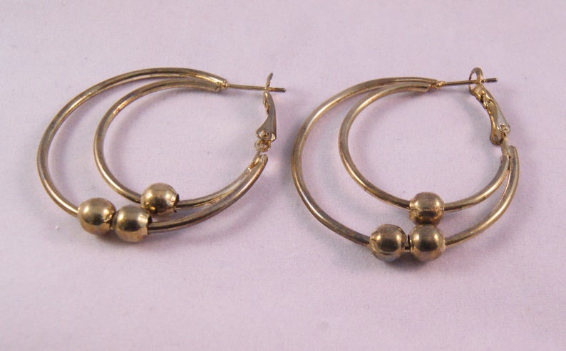Gold tone pierced double hoop earrings with beads
