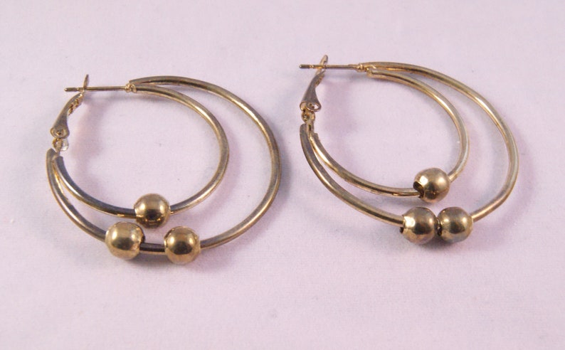 Gold tone pierced double hoop earrings with beads