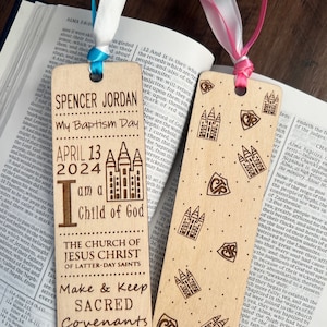 May include: A wooden bookmark with a light brown finish. The bookmark features a design of a church with a steeple and the text "The Church of Jesus Christ of Latter-day Saints". The bookmark also includes the text "Make & Keep Sacred Covenants Choose the Right".