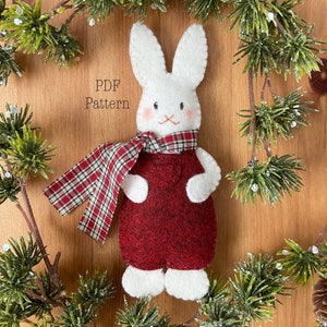 Felt Bunny Christmas Ornament. Felt ornament sewing pattern. Christmas ornament sewing pattern. Felt ornament pattern. Felt rabbit christmas ornament wearing felt overalls and scarf. Bunny in scarf ornament.