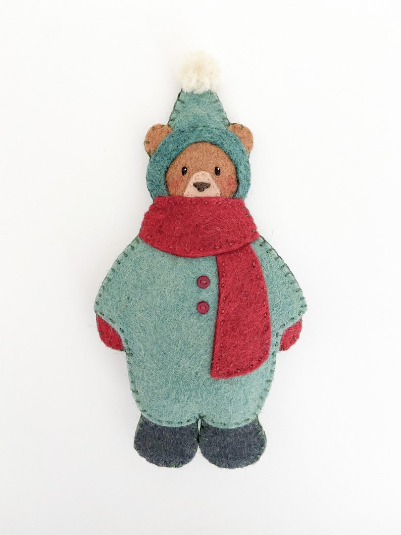 Felt christmas ornament pattern. Cute bear christmas ornament sewing pattern. Christmas sewing pattern. Bear ornament. Bear in snowsuit. Brown bear in green snowsuit with red scarf. DIY Christmas gift. Winter sewing project.