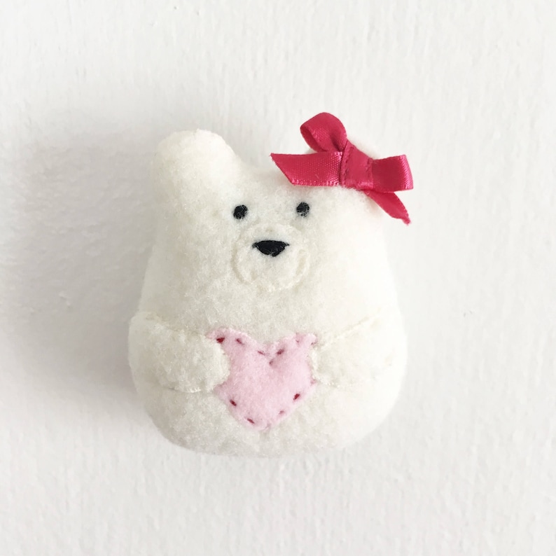 Tiny felt bear ornament pattern. A small white felt bear holding a heart. An ornament for Christmas or Valentines Day. A felt ornament pattern.