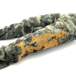 May include: Camouflage trousers with a gold embroidered dragon design.