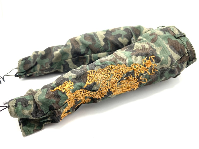 May include: Camouflage trousers with a gold embroidered dragon design.