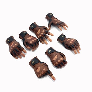 May include: Set of eight brown leather gloves with black accents and fingerless design. The gloves have a textured surface and are arranged in a pattern on a white background.