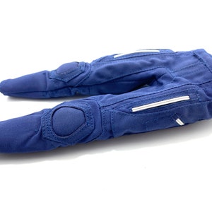 May include: A pair of blue padded gloves with white accents. The gloves have a textured fabric and are designed for protection.