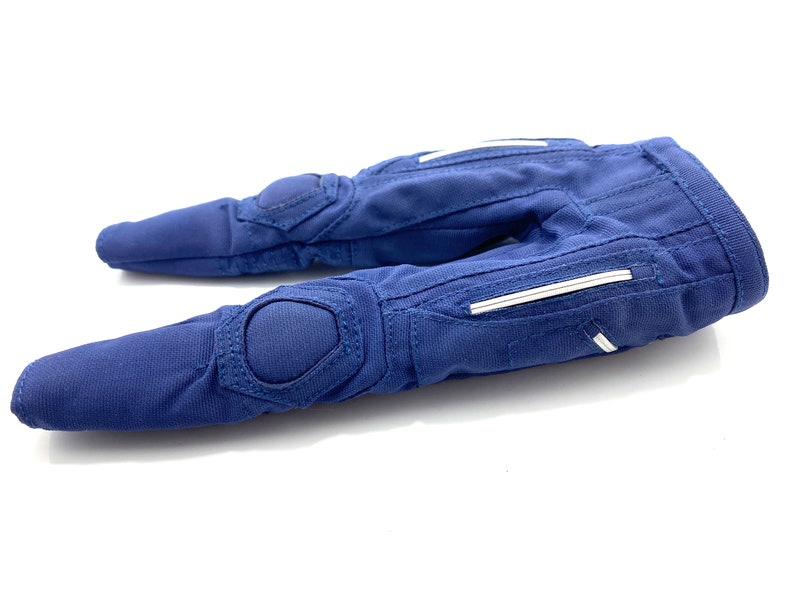 May include: A pair of blue padded gloves with white accents. The gloves have a textured fabric and are designed for protection.