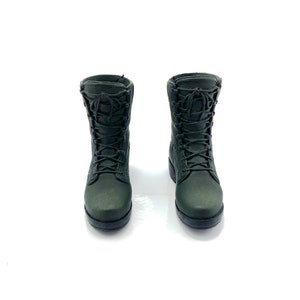 May include: A pair of dark green military-style boots with black laces.