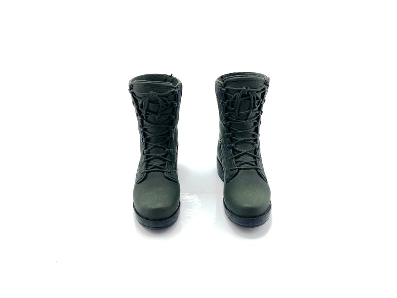 May include: A pair of dark green military-style boots with black laces.