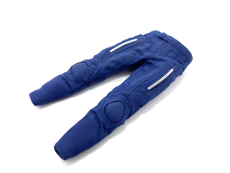 May include: Blue trousers with white accents and knee pads.