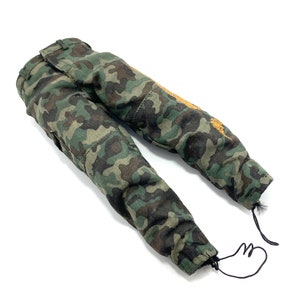 May include: Camouflage trousers with a green, brown and black pattern. The trousers have a drawstring at the bottom of the legs.