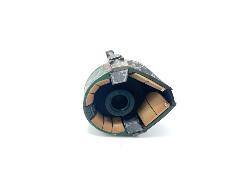 May include: A green and brown helmet with a black lens. The helmet is open and the inside is visible. The inside of the helmet is made of brown and black material.