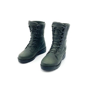 May include: A pair of dark green military-style boots with black laces. The boots are made of a textured material and have a rugged sole.