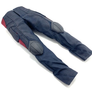 May include: Black trousers with red accents and black knee pads. The trousers are made of a textured fabric.
