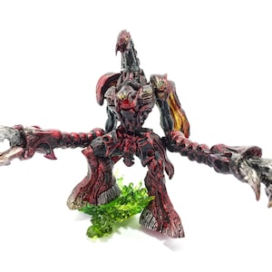 May include: A red and black articulated action figure of a monster with sharp claws and a long tail. The figure is standing on a green base.