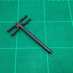 May include: A black plastic tool with three prongs at one end. The tool is designed for use with a specific type of craft project.