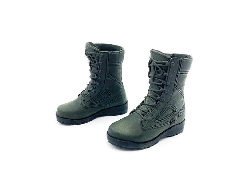 May include: A pair of dark green military-style boots with black laces. The boots have a rugged look and are made of a durable material.