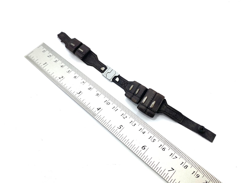 May include: A black leather belt with two pouches on each side. The belt is approximately 16 inches long.