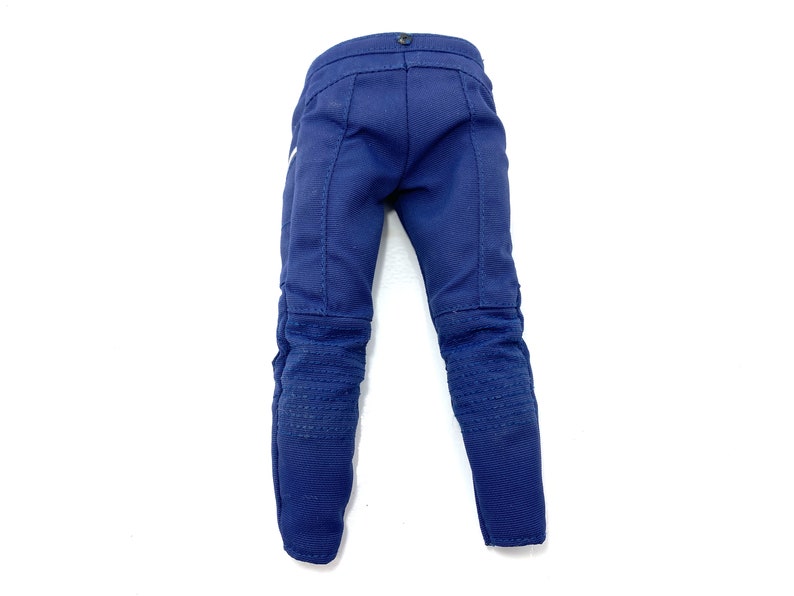 May include: A pair of dark blue denim trousers with knee pads. The trousers have a straight leg and a zip fly.