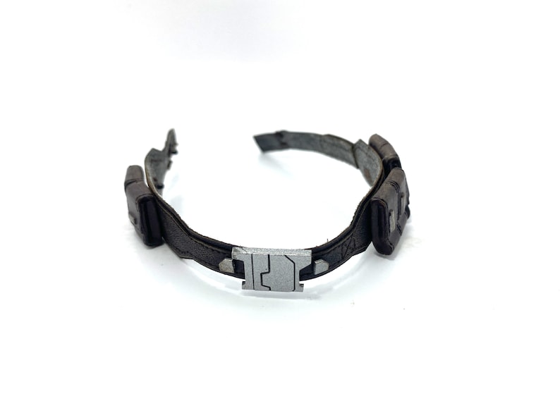 May include: A brown leather belt with a silver buckle and two pouches on the side.