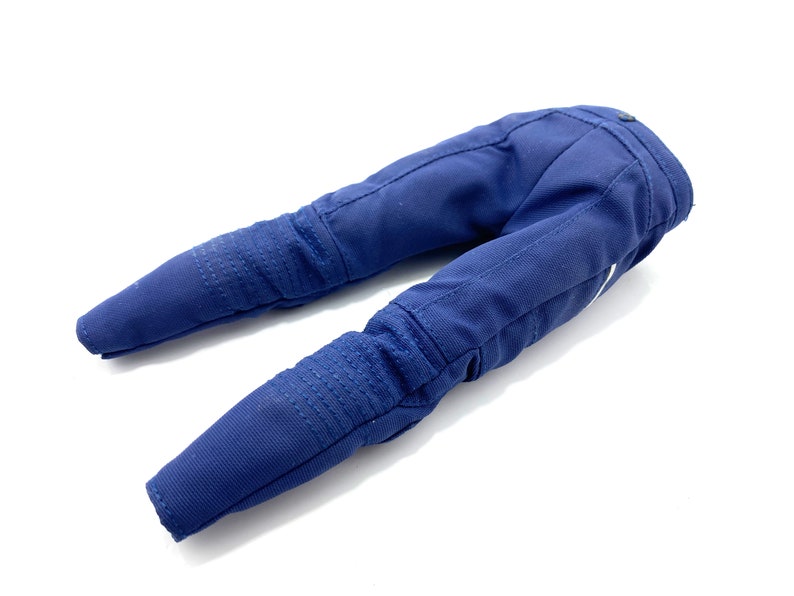 May include: A pair of blue denim trousers with knee pads. The trousers are folded in half and laid flat on a white surface.