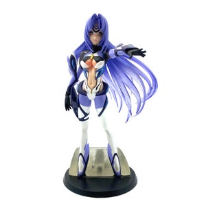 May include: A detailed figurine of a female anime character with long, flowing purple hair and a futuristic outfit. The figure is predominantly white, purple, and black, standing on a small base. The character is posed with one arm extended.