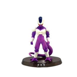 May include: A purple and white action figure of a character with a tail, standing on a brown base. The figure has a white chest and shoulder armor, with a blue head crest. The base has Japanese text.