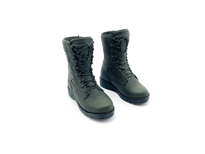 May include: A pair of dark green military-style boots with black laces. The boots are made of a durable material and have a rugged design.