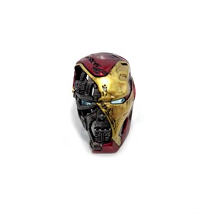 May include: A detailed, half-face replica of an Iron Man helmet. The helmet features a red and gold color scheme, with intricate mechanical detailing and visible internal components. The eye lenses are a bright blue.
