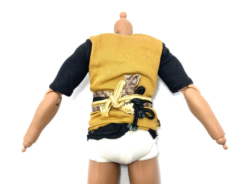 May include: A yellow sleeveless shirt with a black undershirt and a brown and gold belt. The shirt is torn at the bottom.