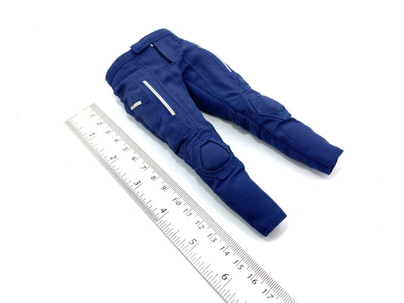 May include: Blue trousers with knee pads and white accents. The trousers are made of a durable fabric and have a zip fly.