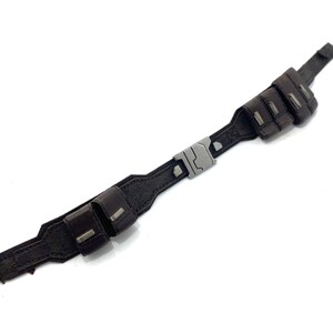 May include: A brown leather belt with a silver buckle and two pouches on each side.