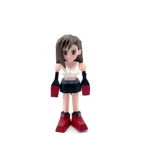 May include: A figurine of a female character with brown hair, red eyes, and a white top. She wears a black skirt, red boots, and red and black arm guards. The figure is standing on a white surface.