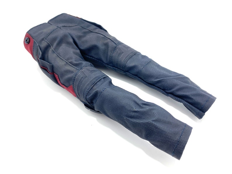 May include: Black trousers with red accents. The trousers have a textured fabric and are designed for motorcycle riding.