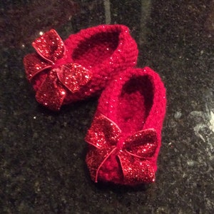 Ruby red slipper booties for your newborn, because there’s no place like home.