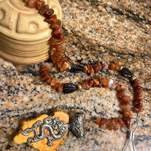 Hand carved ceramic bell with semi precious stones