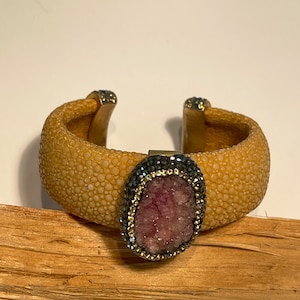 Flexible stingray bracelet, large pink Druzy stone surrounded by Marcasites, and gold cz’s as accents