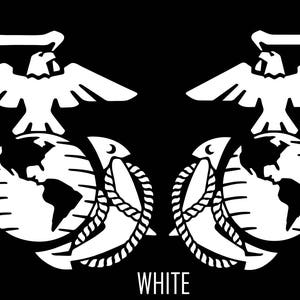 May include: A black and white image of the United States Marine Corps emblem, featuring a globe, an eagle, and an anchor. The emblem is centred on a black background with the word "WHITE" printed below it.