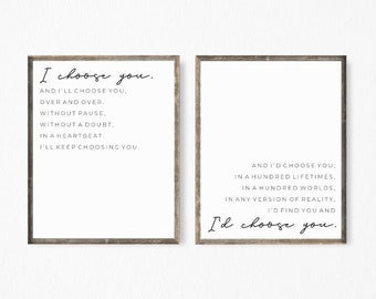 May include: Two framed prints with white backgrounds and black text. The left print reads "I choose you" followed by a poem. The right print reads "And I'd choose you" followed by a poem. The frames are a light brown colour.