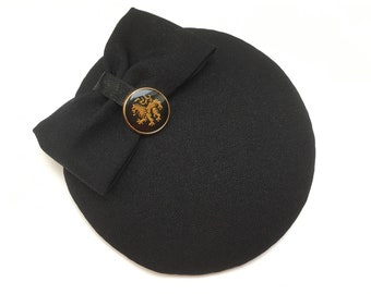 black hat with bow, vintage lion button, headpiece, elegant, puristic