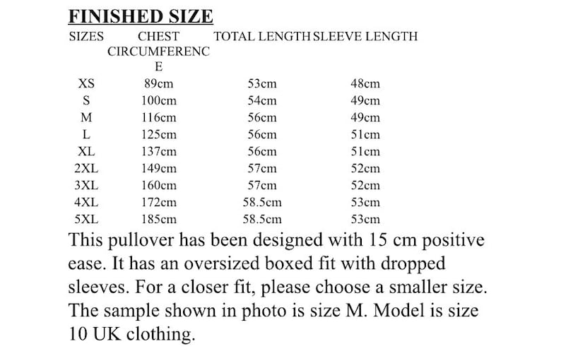 May include: Size chart for a pullover with measurements in centimeters for chest circumference, total length, and sleeve length. Sizes range from XS to 5XL. The text states that the pullover has been designed with 15 cm of positive ease and has an oversized boxed fit with dropped sleeves. It also states that the sample shown in the photo is size M and the model is size 10 UK clothing.