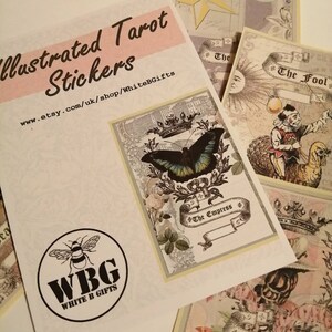 May include: Illustrated Tarot stickers featuring The Empress, The Fool, and The High Priestess cards. The Empress card features a butterfly and a crown. The Fool card features a jester with a bird. The High Priestess card features a bird and a crown.