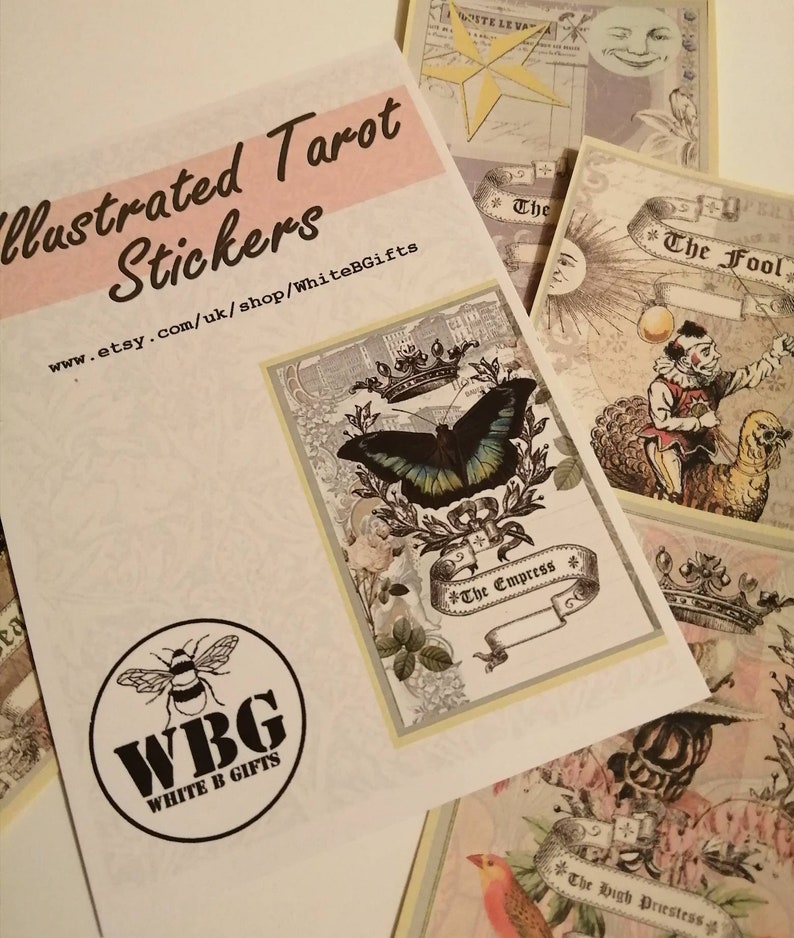 May include: Illustrated Tarot stickers featuring The Empress, The Fool, and The High Priestess cards. The Empress card features a butterfly and a crown. The Fool card features a jester with a bird. The High Priestess card features a bird and a crown.