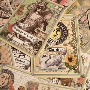 May include: A collection of tarot cards with various designs, including a Queen of Cups, The Sun, and The Empress. The cards are decorated with intricate details and imagery.